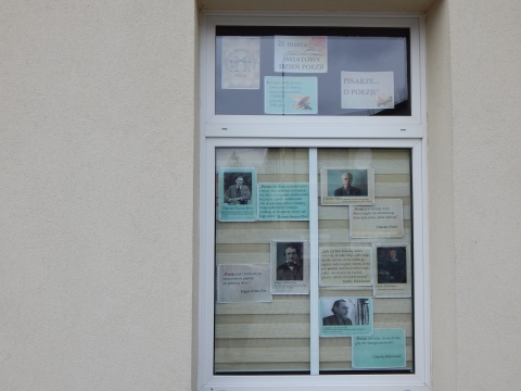 Zdjęcie prezentuje wystawę na oknach Powiatowej Biblioteki Publicznej w Puławach pokazującą różne definicje słowa poezja. 