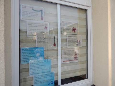 Zdjęcie prezentuje wystawę na oknach Powiatowej Biblioteki Publicznej w Puławach pokazującą najpiękniejsze wiersze o tematyce świątecznej polskich poetów. 